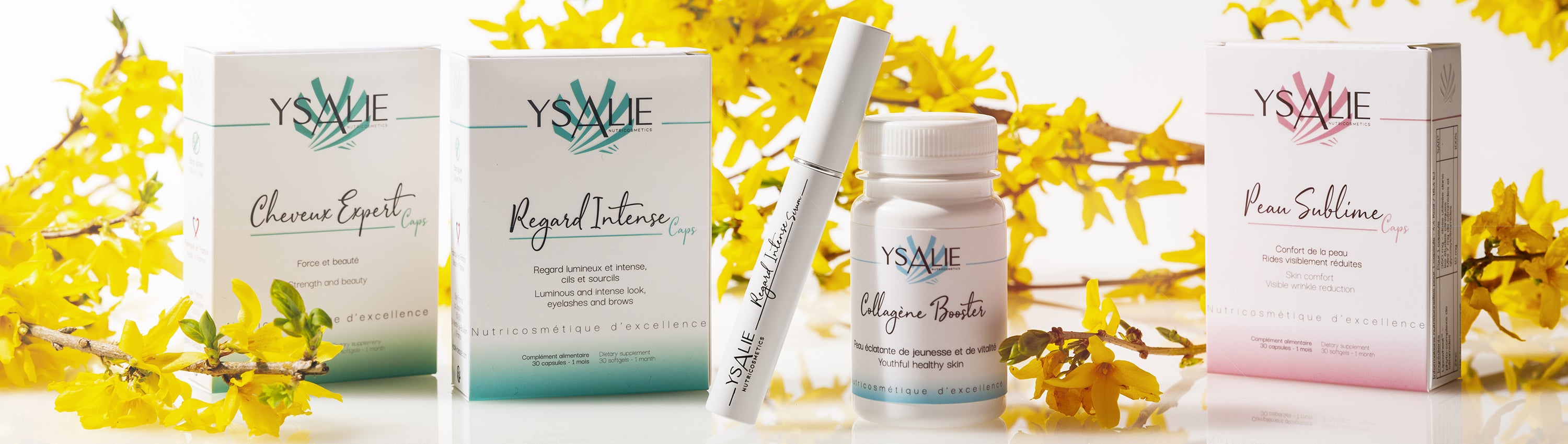 Produits Ysalie, compléments alimentaires et sérum présentés sur un fond blanc et entourés de fleurs jaunes